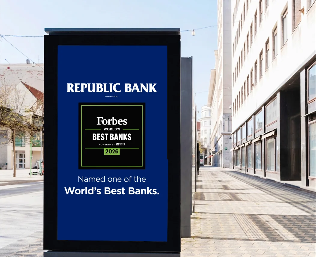 Outdoor street display shows a Republic Bank ad featuring the “Forbes World’s Best Banks 2026” badge and the text “Named one of the World’s Best Banks.”